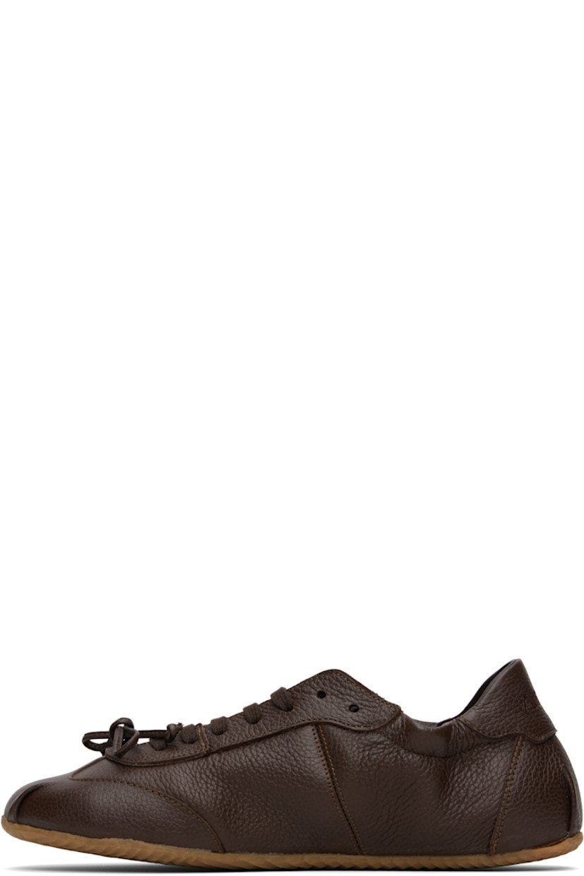 Low-top grained leather sneakers in brown.

· Square toe
· Bow accent at vamp
· Lace-up closure
· Logo embroidered at padded tongue
· Elasticized collar
· Logo embroidered at heel tab
· Buffed leather and suede lining
· Treaded rubber sole

Supplier color: Brown