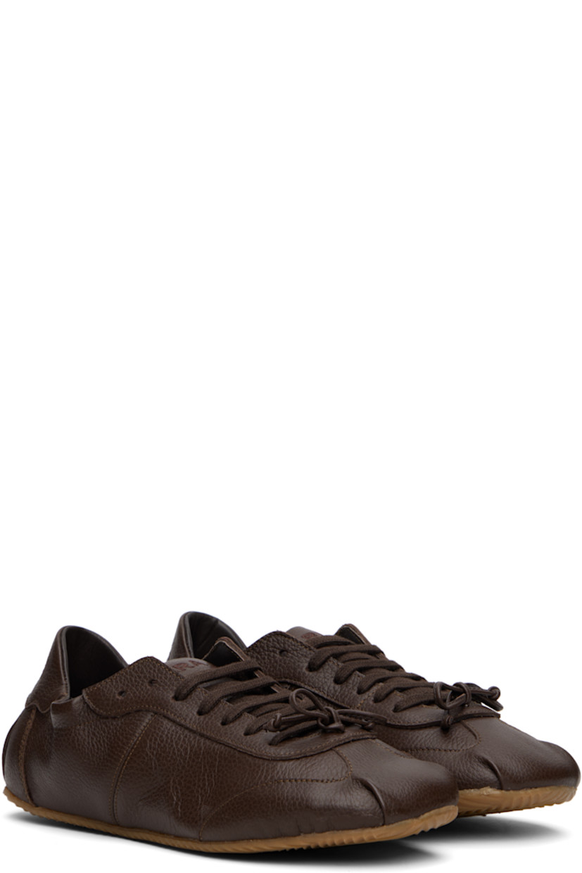 Low-top grained leather sneakers in brown.

· Square toe
· Bow accent at vamp
· Lace-up closure
· Logo embroidered at padded tongue
· Elasticized collar
· Logo embroidered at heel tab
· Buffed leather and suede lining
· Treaded rubber sole

Supplier color: Brown