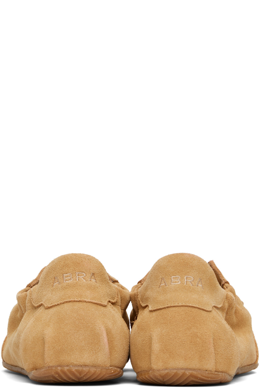 Low-top suede sneakers in tan.

· Square toe
· Bow accent at vamp
· Lace-up closure
· Logo embroidered at padded tongue
· Elasticized collar
· Logo embroidered at heel tab
· Suede and jersey lining
· Treaded rubber sole

Supplier color: Camel