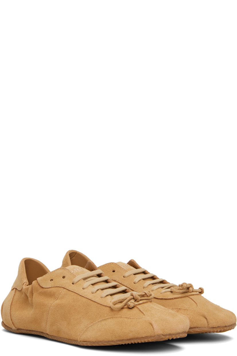 Low-top suede sneakers in tan.

· Square toe
· Bow accent at vamp
· Lace-up closure
· Logo embroidered at padded tongue
· Elasticized collar
· Logo embroidered at heel tab
· Suede and jersey lining
· Treaded rubber sole

Supplier color: Camel