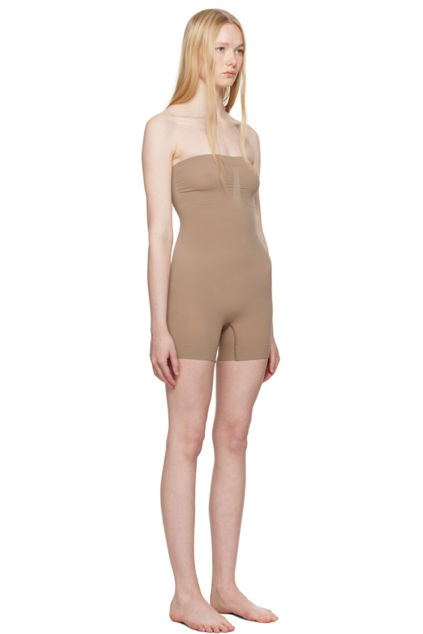 Stretch recycled nylon-blend jersey bodysuit. Includes adjustable and detachable shoulder straps for alternate styling.

· Elasticized straight neck
· Ruching at chest
· High-compression waist
· Lapped gusset at bottom

Supplier color: Sienna