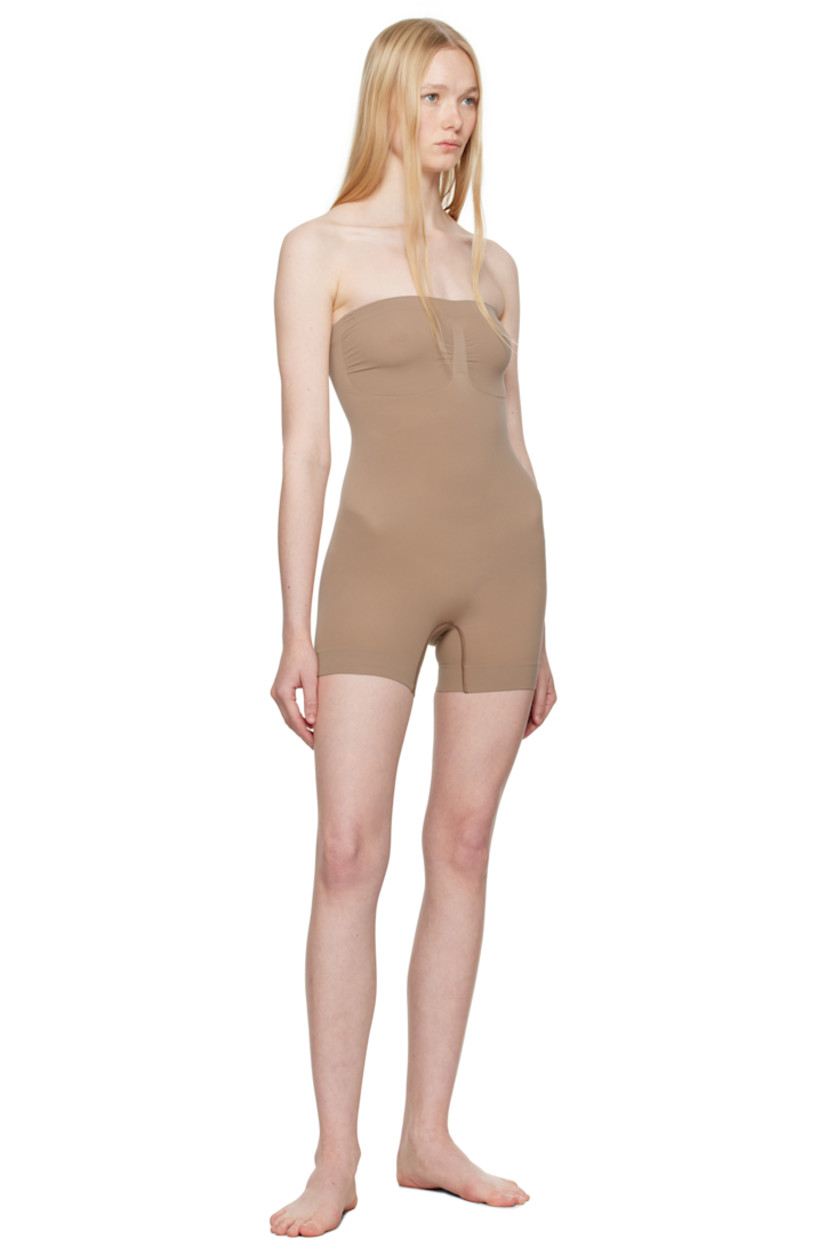 Stretch recycled nylon-blend jersey bodysuit. Includes adjustable and detachable shoulder straps for alternate styling.

· Elasticized straight neck
· Ruching at chest
· High-compression waist
· Lapped gusset at bottom

Supplier color: Sienna