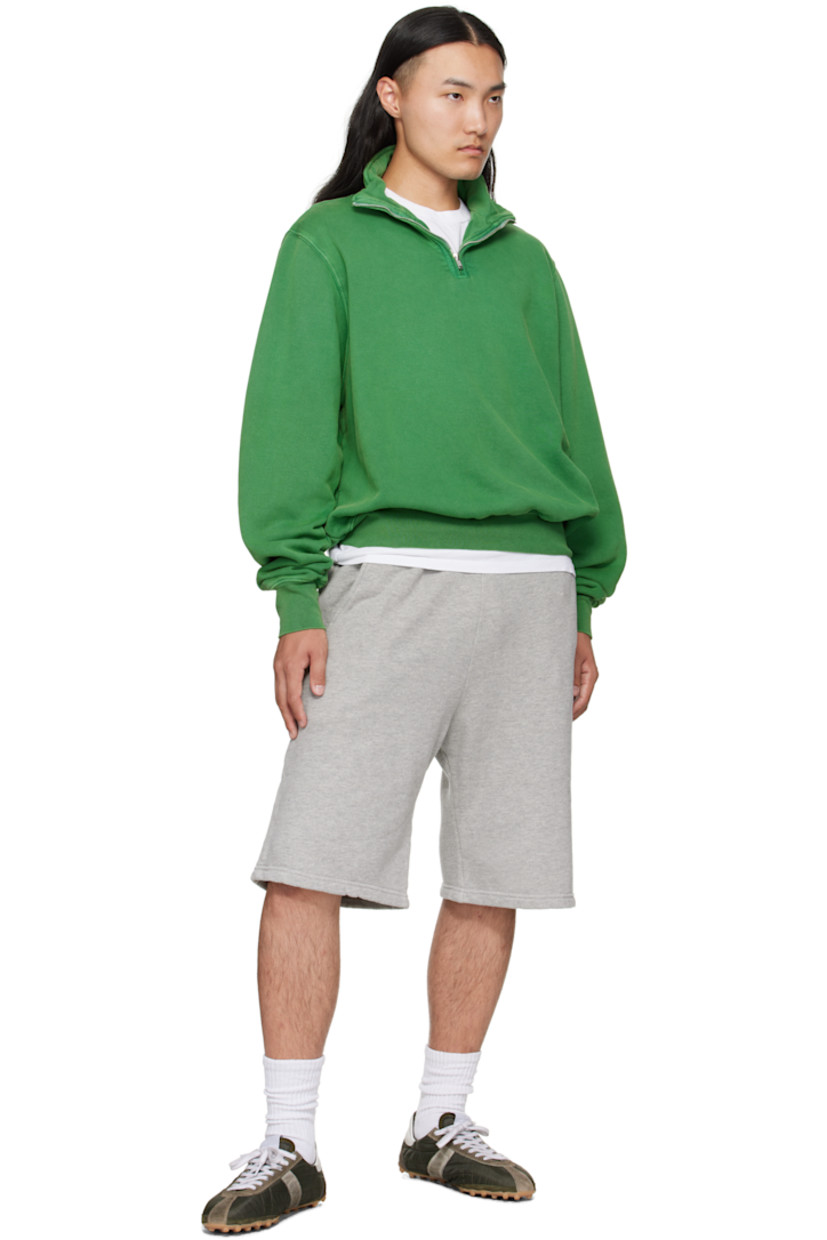 Heavyweight brushed cotton fleece sweatshirt.

· Pre-shrunk and garment-dyed
· Fading throughout
· Stand collar
· Half-zip closure
· Rib-knit hem and cuffs
· Dropped shoulders

Supplier color: Washed basil
