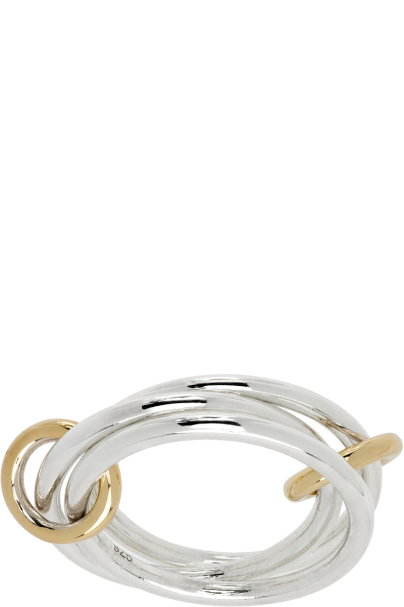 Handcrafted stacked rings in sterling silver. Connecting hoops in 18k gold at length.

Supplier color: Yellow gold/Silver