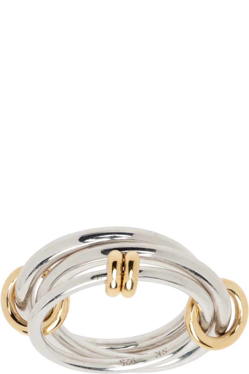 Handcrafted stacked rings in sterling silver.

· Connecting hoops and O-rings in 18k yellow gold
· Hallmarking at inner band

Supplier color: Silver/Gold