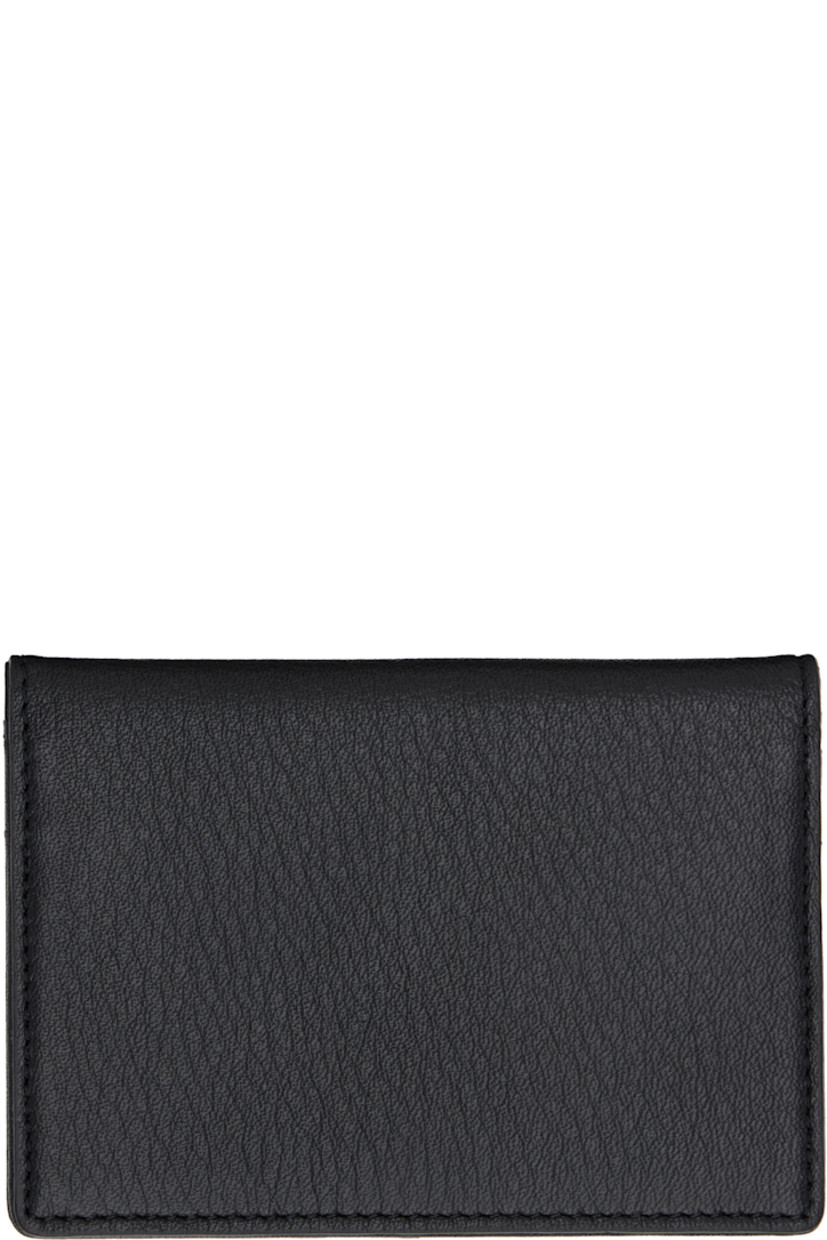 Grained leather bifold card holder. 

· Embossed logo at face
· Four card slots at interior 
· H3" x W4.5"

Part of the discord YOHJI YAMAMOTO collection.

Supplier color: Black