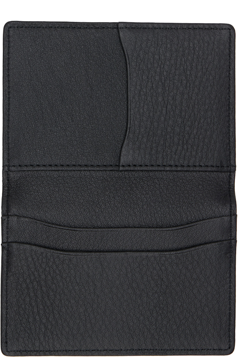 Grained leather bifold card holder. 

· Embossed logo at face
· Four card slots at interior 
· H3" x W4.5"

Part of the discord YOHJI YAMAMOTO collection.

Supplier color: Black