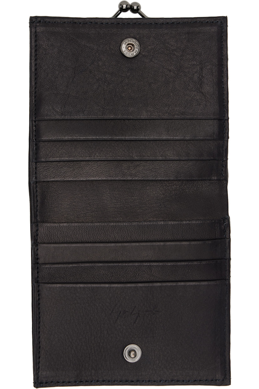 Grained leather bifold wallet. 

· Kiss-lock coin pouch at face
· Eight card slots at interior 
· One note slot 
· Gunmetal-tone hardware
· H4" x W3.5" x D0.5"

Part of the discord YOHJI YAMAMOTO collection.

Supplier color: Black