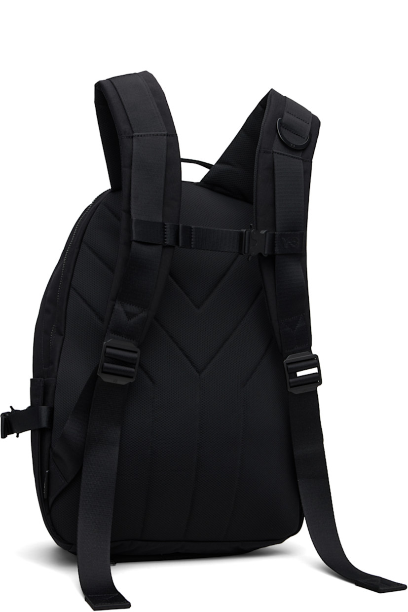 Nylon canvas backpack. Zip pocket at base with detachable waterproof bag cover.

· Carry handle at top
· Padded shoulder straps with D-ring
· Sternum strap with rollercoaster buckle
· Logo embroidered at face
· Two-way zip compartment with pocket at face
· Pocket with rollercoaster buckle at sides
· Two-way zip closure at main compartment
· Padded laptop compartment and patch pocket
· Twill lining
· H17" x W16" x D5"

Part of the Yohji Yamamoto Y-3 KURO collection.

Supplier color: Black