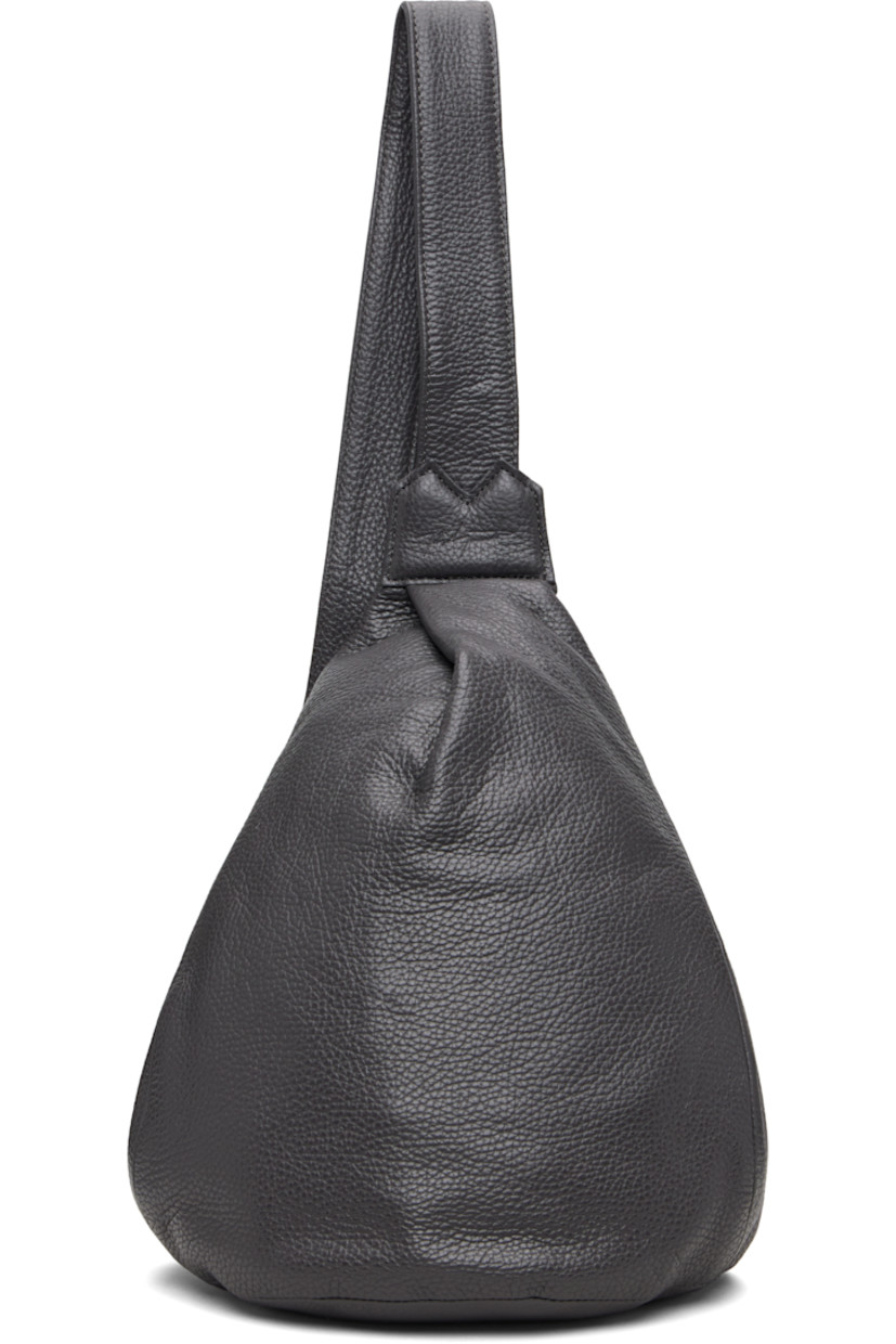 Grained leather shoulder bag.

· Convertible and adjustable crossbody strap
· Converts from left or right shoulder
· Pleat and embossed logo at face
· Zip closure at back face
· Zip pocket at interior
· Twill lining
· H13" x W9" x D4.5"

Part of the discord YOHJI YAMAMOTO collection.

Supplier color: Dark Grey