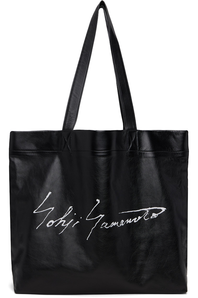 Grained leather tote.

· Fixed shoulder straps
· Logo printed at face
· Patch pocket at interior
· Twill lining
· H14" x W19" x D5"

Part of the discord YOHJI YAMAMOTO collection.

Supplier color: Black