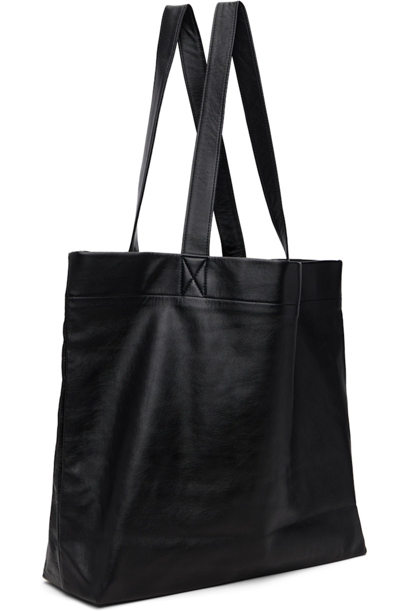 Grained leather tote.

· Fixed shoulder straps
· Logo printed at face
· Patch pocket at interior
· Twill lining
· H14" x W19" x D5"

Part of the discord YOHJI YAMAMOTO collection.

Supplier color: Black