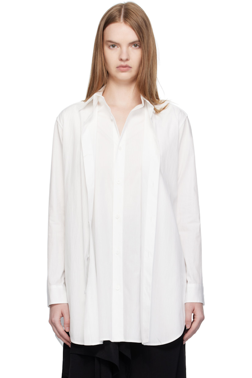 Cotton broadcloth shirt. 

· Layered construction
· Spread collar 
· Button closure
· Shirttail hem 
· Buttoned barrel cuffs
· Box pleat at back yoke 

Part of 'Yohji Yamamoto collections'.

Supplier color: Off white
