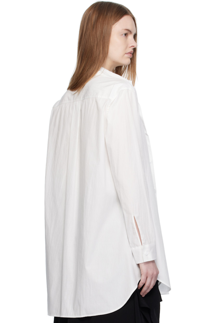 Cotton broadcloth shirt. 

· Layered construction
· Spread collar 
· Button closure
· Shirttail hem 
· Buttoned barrel cuffs
· Box pleat at back yoke 

Part of 'Yohji Yamamoto collections'.

Supplier color: Off white