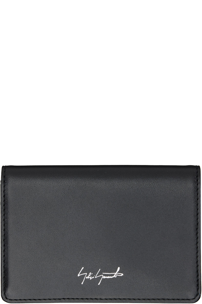 Buffed leather bifold card holder.

· Logo printed at face
· Card slot at back face
· Two card slots and two patch pockets
· Canvas lining
· H3" x W4.25" x D0.5"

Part of the discord YOHJI YAMAMOTO collection.

Supplier color: Black