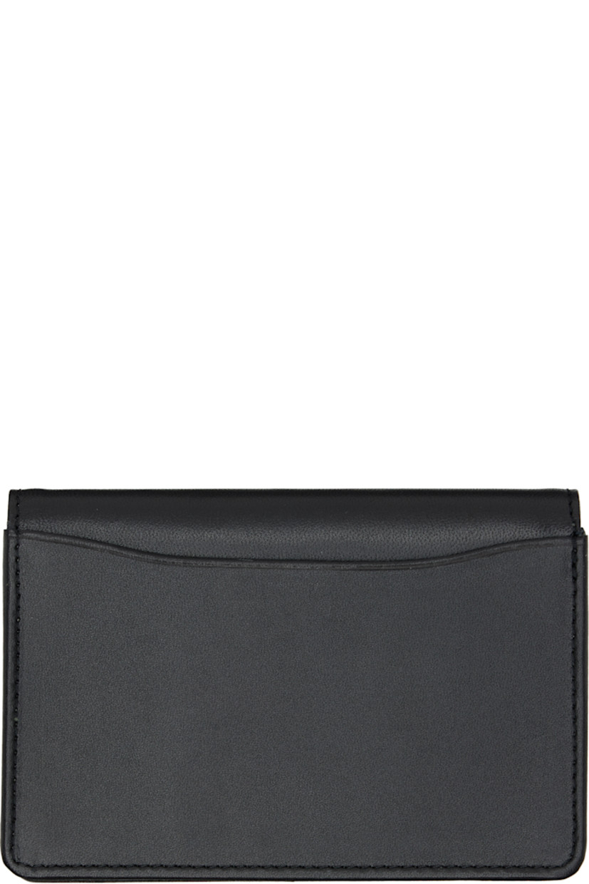 Buffed leather bifold card holder.

· Logo printed at face
· Card slot at back face
· Two card slots and two patch pockets
· Canvas lining
· H3" x W4.25" x D0.5"

Part of the discord YOHJI YAMAMOTO collection.

Supplier color: Black