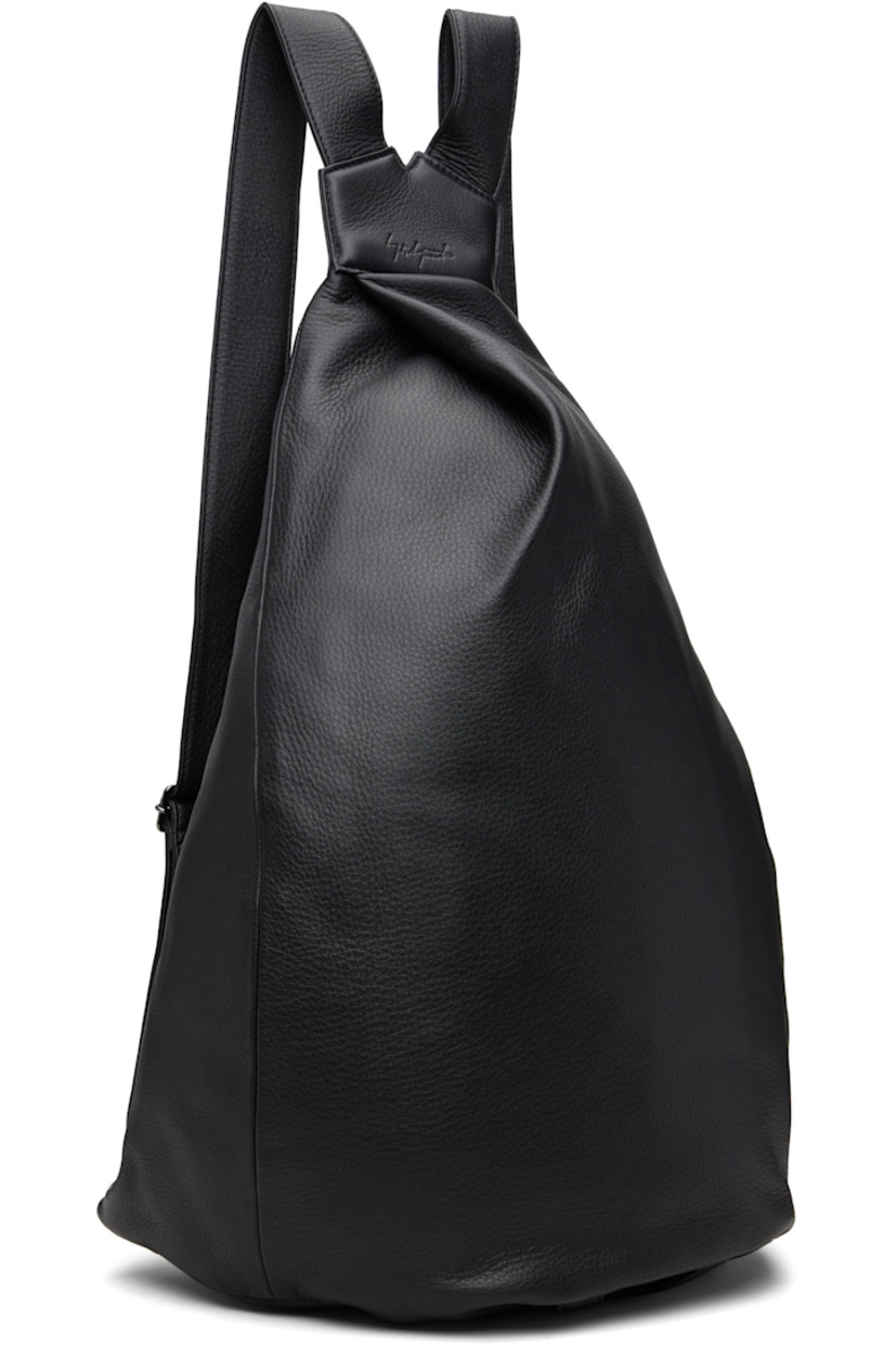 Grained leather backpack.

· Twin adjustable shoulder straps
· Pleat and embossed logo at top
· Main zip compartment and pocket at back face
· Logo tab at base
· Zip pocket at interior
· Twill lining
· H20" x W15" x D8"

Part of the discord YOHJI YAMAMOTO collection.

Supplier color: Black