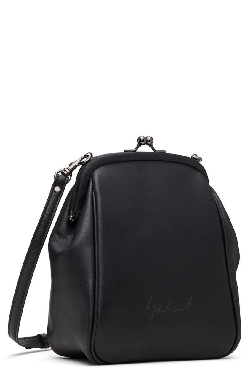 Grained leather shoulder bag.

· Adjustable and detachable crossbody strap
· Logo embossed at face
· Kiss-lock closure
· Patch pocket at interior
· Twill lining
· H7" x W5.5" x D3"

Supplier color: Black