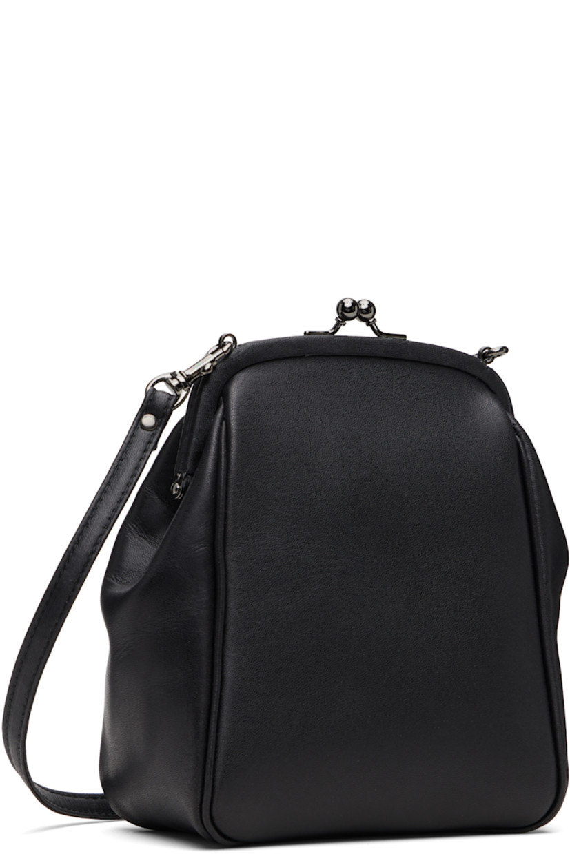 Grained leather shoulder bag.

· Adjustable and detachable crossbody strap
· Logo embossed at face
· Kiss-lock closure
· Patch pocket at interior
· Twill lining
· H7" x W5.5" x D3"

Supplier color: Black