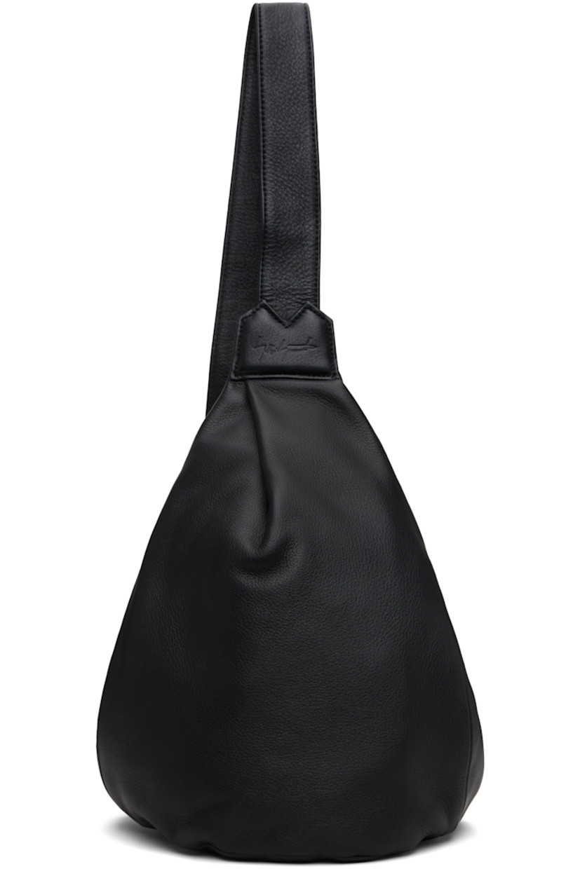 Grained leather shoulder bag.

· Convertible and adjustable crossbody strap
· Converts from left or right shoulder
· Pleat and embossed logo at face
· Zip closure at back face
· Zip pocket at interior
· Twill lining
· H13" x W9" x D4.5"

Part of the discord YOHJI YAMAMOTO collection.

Supplier color: Black
