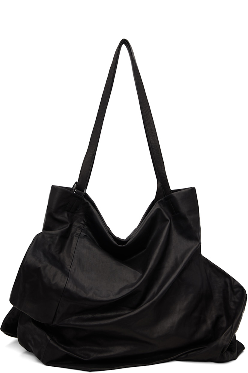 Grained leather tote.

· Darts throughout
· Adjustable shoulder straps
· Zip closure
· Zip pocket at interior
· Twill lining
· H17" x W24" x D12"

Part of the discord YOHJI YAMAMOTO collection.

Supplier color: Black