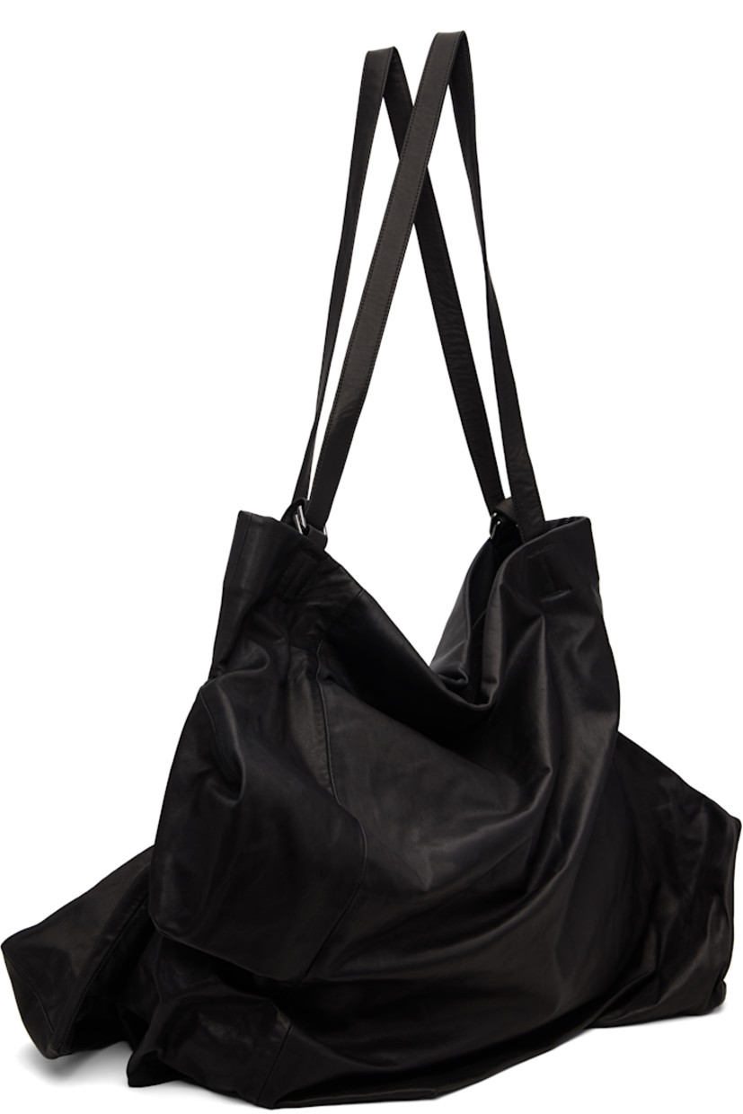 Grained leather tote.

· Darts throughout
· Adjustable shoulder straps
· Zip closure
· Zip pocket at interior
· Twill lining
· H17" x W24" x D12"

Part of the discord YOHJI YAMAMOTO collection.

Supplier color: Black
