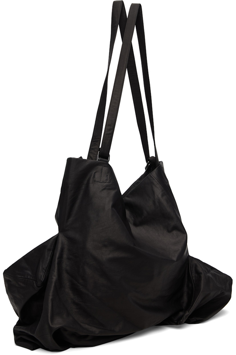 Grained leather tote.

· Darts throughout
· Adjustable shoulder straps
· Zip closure
· Zip pocket at interior
· Twill lining
· H17" x W24" x D12"

Part of the discord YOHJI YAMAMOTO collection.

Supplier color: Black
