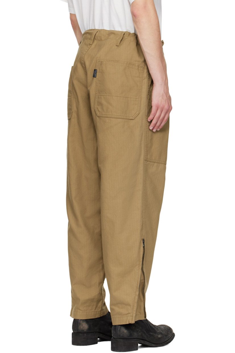 Cotton herringbone trousers.

· Concealed drawstring at waistband
· Belt loops
· Four-pocket styling
· Zip fly
· Zip expansion panel at cuffs
· Logo flag at back pocket

Part of the Yohji Yamamoto POUR HOMME collection.

Supplier color: Beige