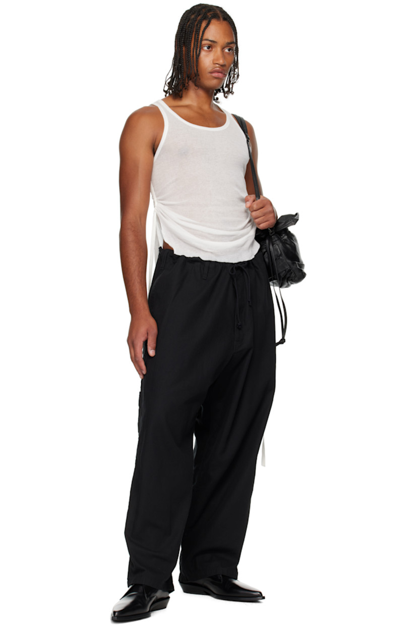 Cotton herringbone trousers.

· Drawstring at waistband 
· Belt loops
· Four-pocket styling
· Zip fly 
· Hammer loop and patch pocket at outseams

Supplier color: Black