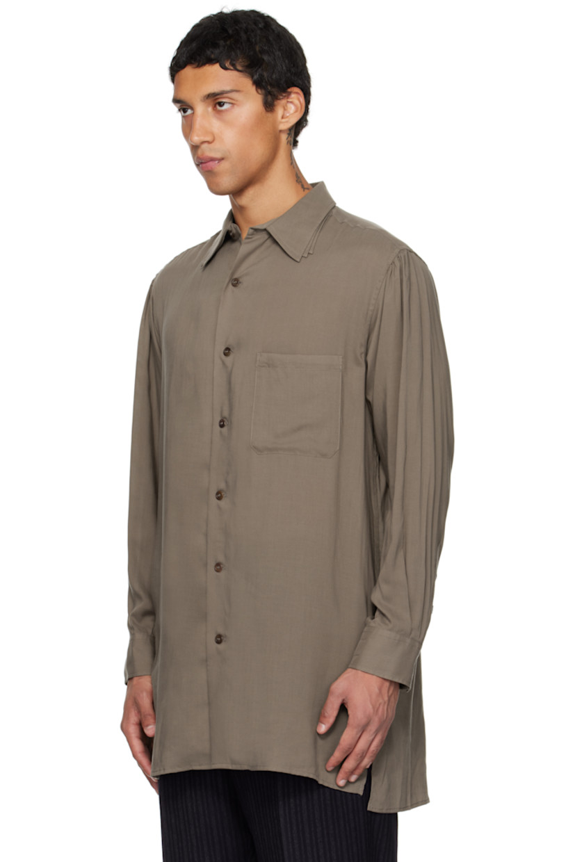 Cellulose poplin shirt.

· Layered spread collars
· Button closure
· Patch pocket at chest
· Droptail hem
· Vented side seams
· Gathering at shoulders
· Buttoned barrel cuffs
· Box pleat at back yoke

Part of the Yohji Yamamoto POUR HOMME collection.

Supplier color: Khaki