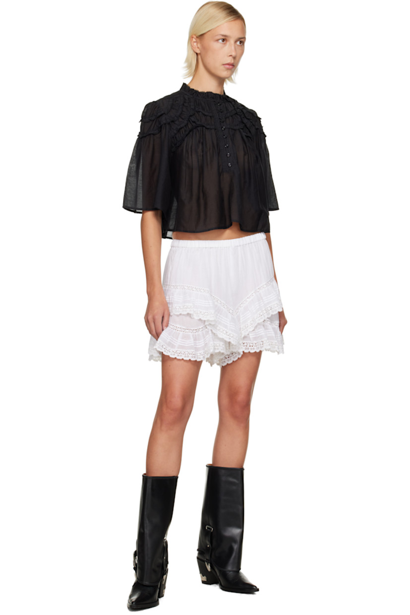 Semi-sheer organic cotton voile shorts.

· Tiered construction 
· Broderie anglaise detailing, pintucks, and ruffles throughout 
· Elasticized waistband 

Supplier color: White