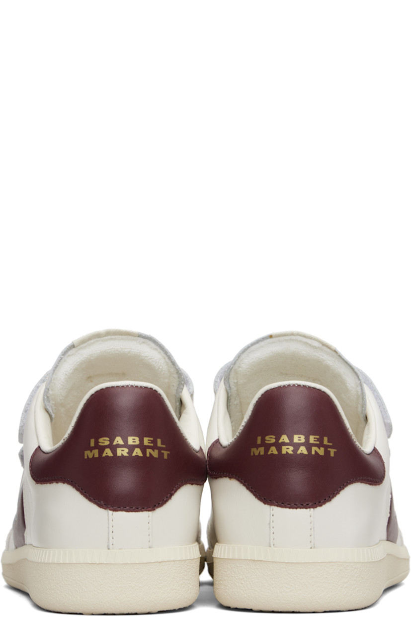 Low-top buffed leather sneakers.

· Perforated detailing at toe
· Velcro closure
· Logo patch at padded tongue
· Padded collar
· Inset logo at outer side
· Logo stamp at heel tab
· Terrycloth lining
· Treaded rubber sole

Supplier color: Ecru/Burgundy