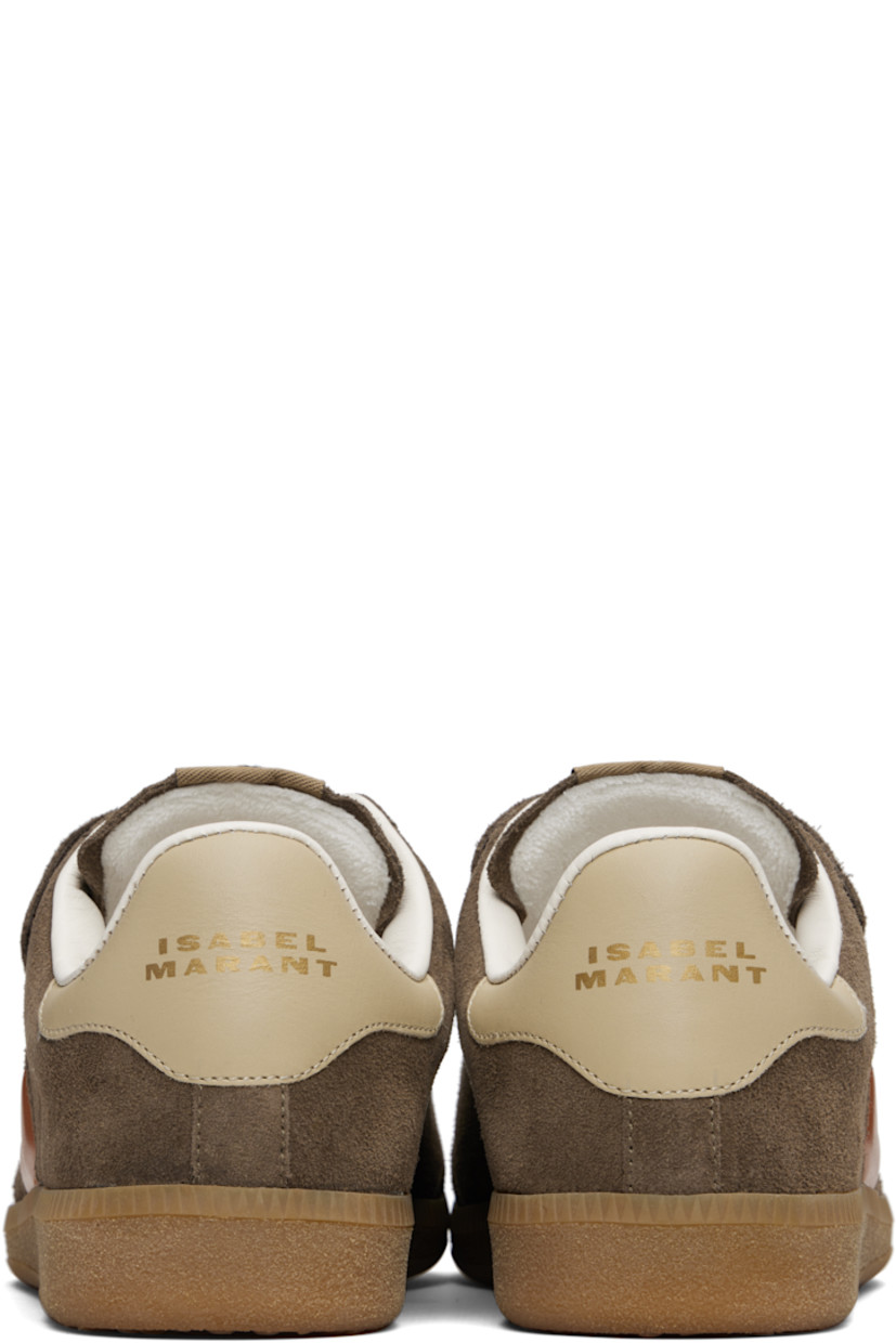 Low-top suede sneakers.

· Perforated detailing at toe
· Velcro closure
· Logo patch at padded tongue
· Padded collar
· Inset logo at outer side
· Logo stamp at heel tab
· Terrycloth lining
· Treaded rubber sole

Supplier color: Khaki/Orange