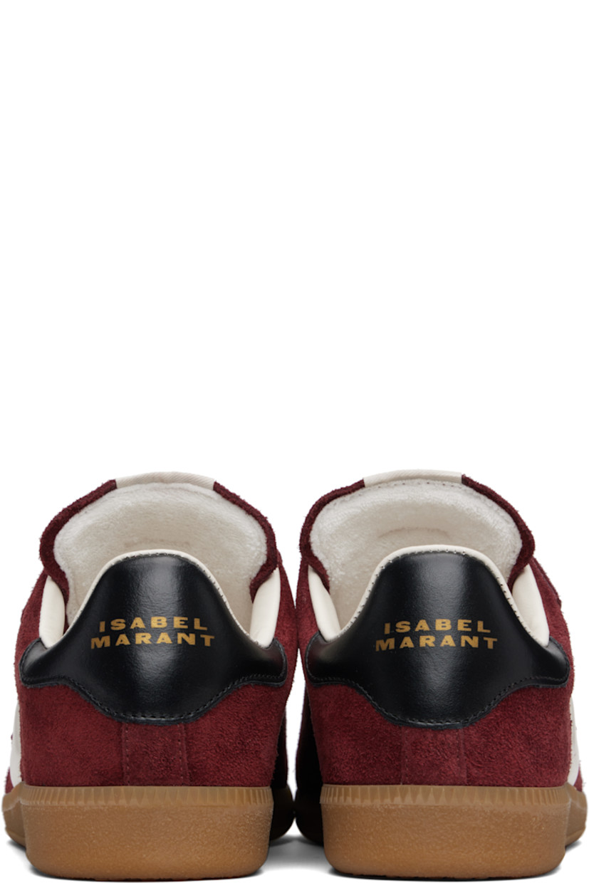 Low-top suede sneakers.

· Perforated detailing at toe
· Velcro closure
· Logo patch at padded tongue
· Padded collar
· Inset logo at outer side
· Logo stamp at heel tab
· Terrycloth lining
· Treaded rubber sole

Supplier color: Burgundy/Ecru