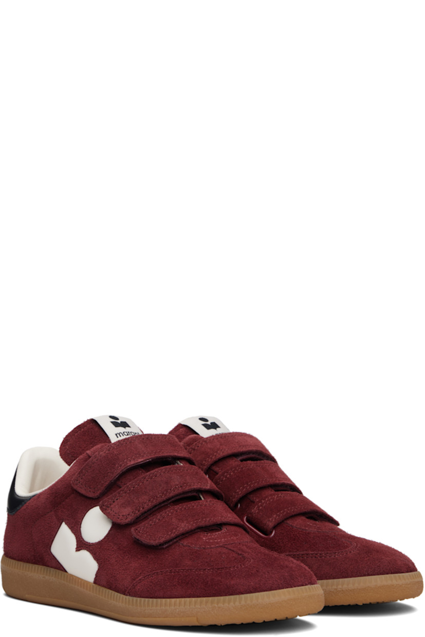 Low-top suede sneakers.

· Perforated detailing at toe
· Velcro closure
· Logo patch at padded tongue
· Padded collar
· Inset logo at outer side
· Logo stamp at heel tab
· Terrycloth lining
· Treaded rubber sole

Supplier color: Burgundy/Ecru