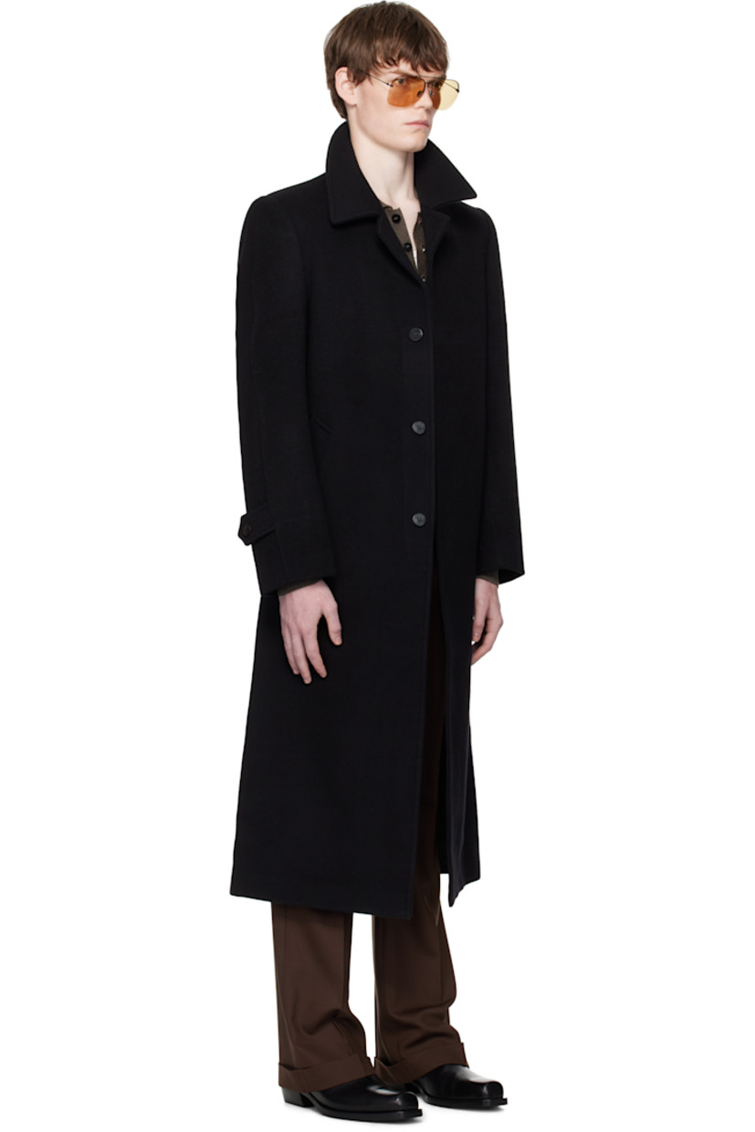 Wool- and cashmere-blend melton coat. 

· Spread collar
· Button closure
· Welt pockets 
· Padded shoulders
· Button tab at cuffs
· Central vent at back hem
· Welt pocket at interior
· Full satin lining

Supplier color: Black