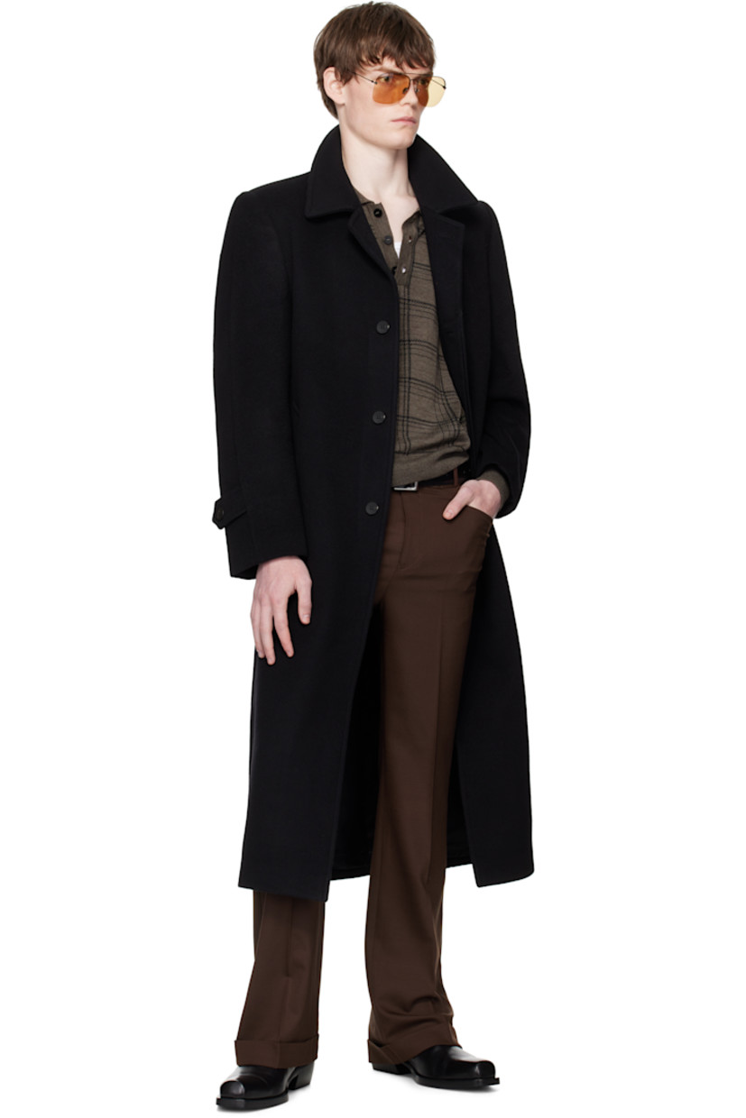 Wool- and cashmere-blend melton coat. 

· Spread collar
· Button closure
· Welt pockets 
· Padded shoulders
· Button tab at cuffs
· Central vent at back hem
· Welt pocket at interior
· Full satin lining

Supplier color: Black