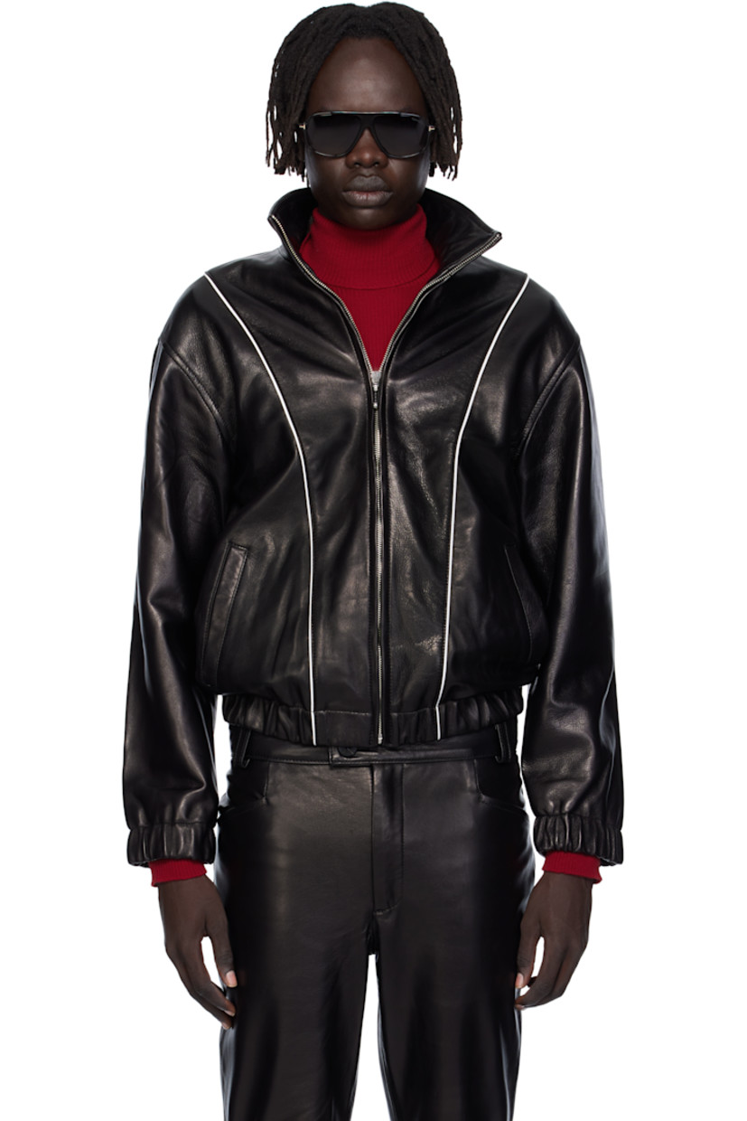 Grained lambskin jacket. 

· Piping throughout
· Stand collar 
· Zip closure
· Welt pockets at waist
· Elasticized hem and cuffs
· Full satin twill lining

Supplier color: Black leather