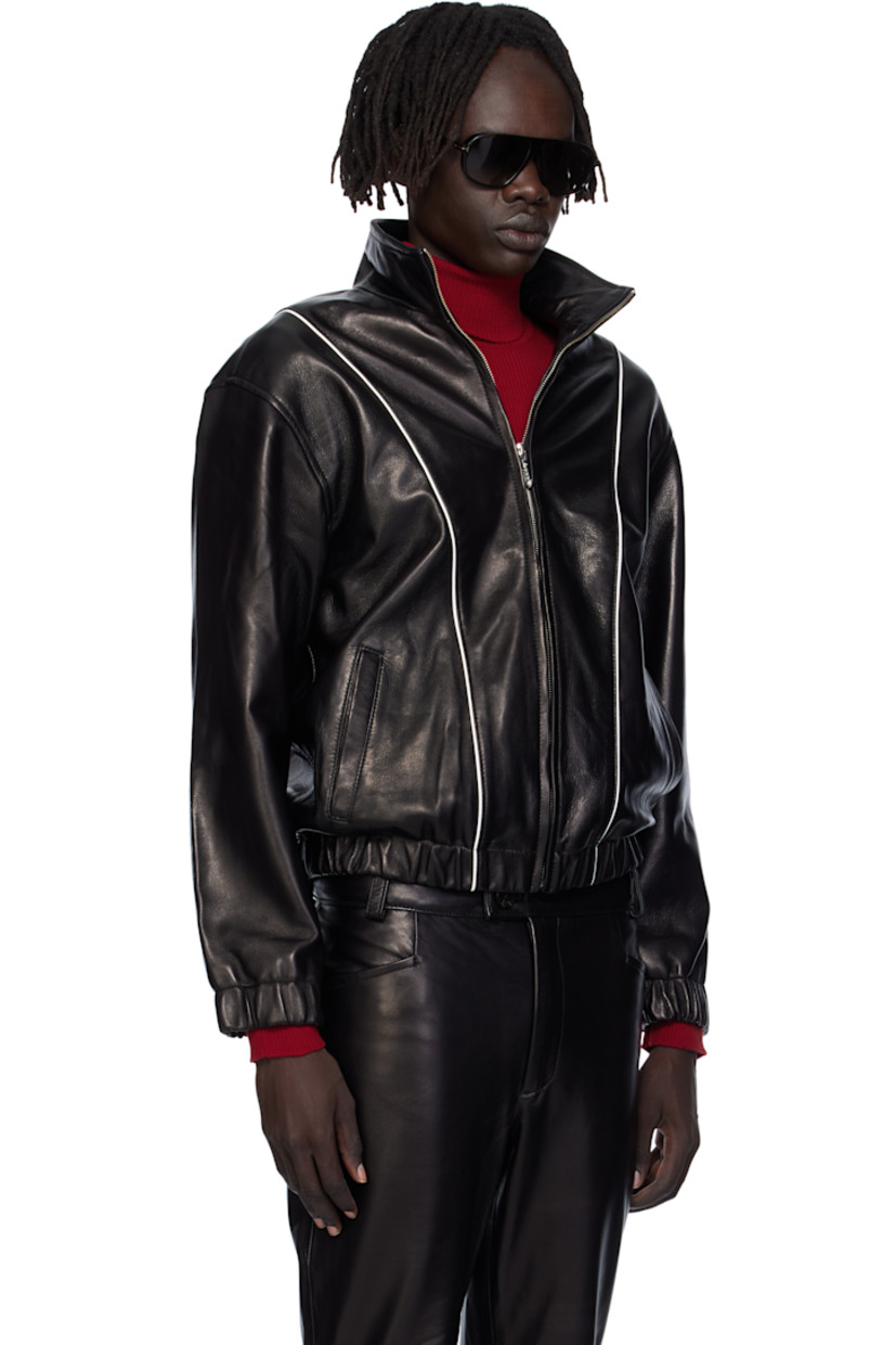 Grained lambskin jacket. 

· Piping throughout
· Stand collar 
· Zip closure
· Welt pockets at waist
· Elasticized hem and cuffs
· Full satin twill lining

Supplier color: Black leather