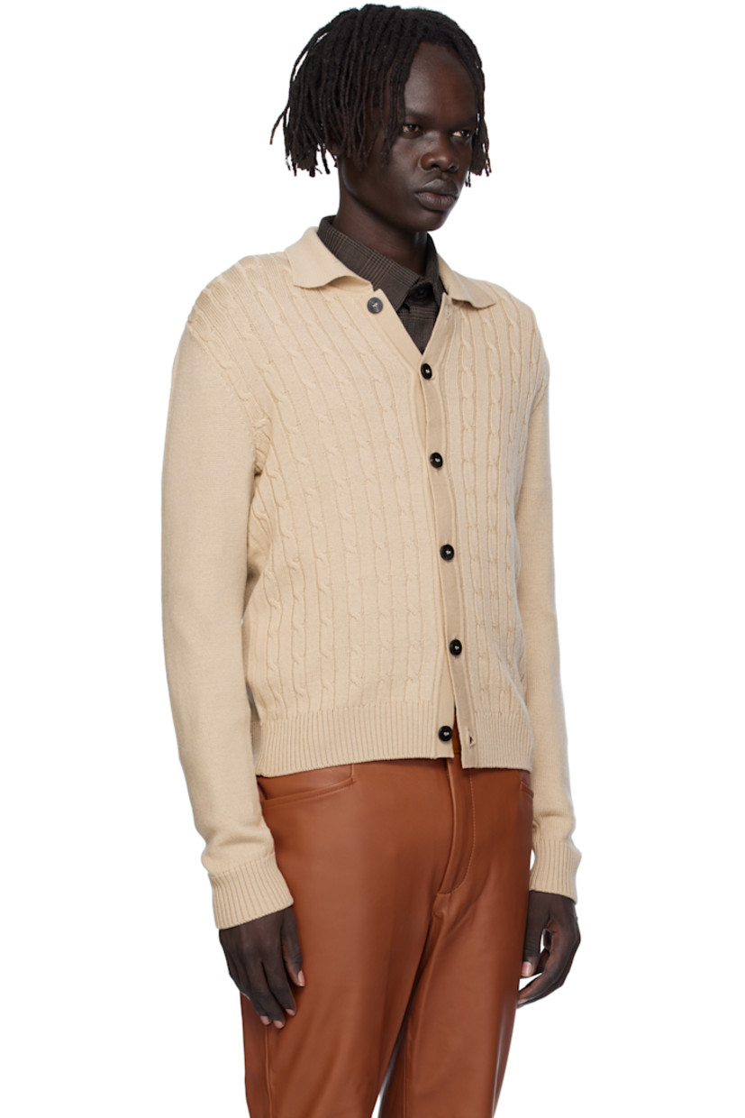 Cable-knit virgin wool cardigan.

· Rib-knit spread collar, placket, hem, and cuffs
· Button closure

Supplier color: Camel