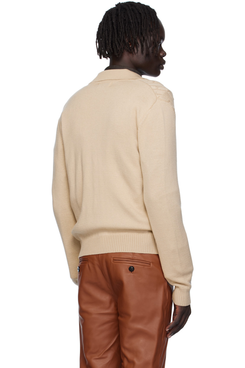 Cable-knit virgin wool cardigan.

· Rib-knit spread collar, placket, hem, and cuffs
· Button closure

Supplier color: Camel