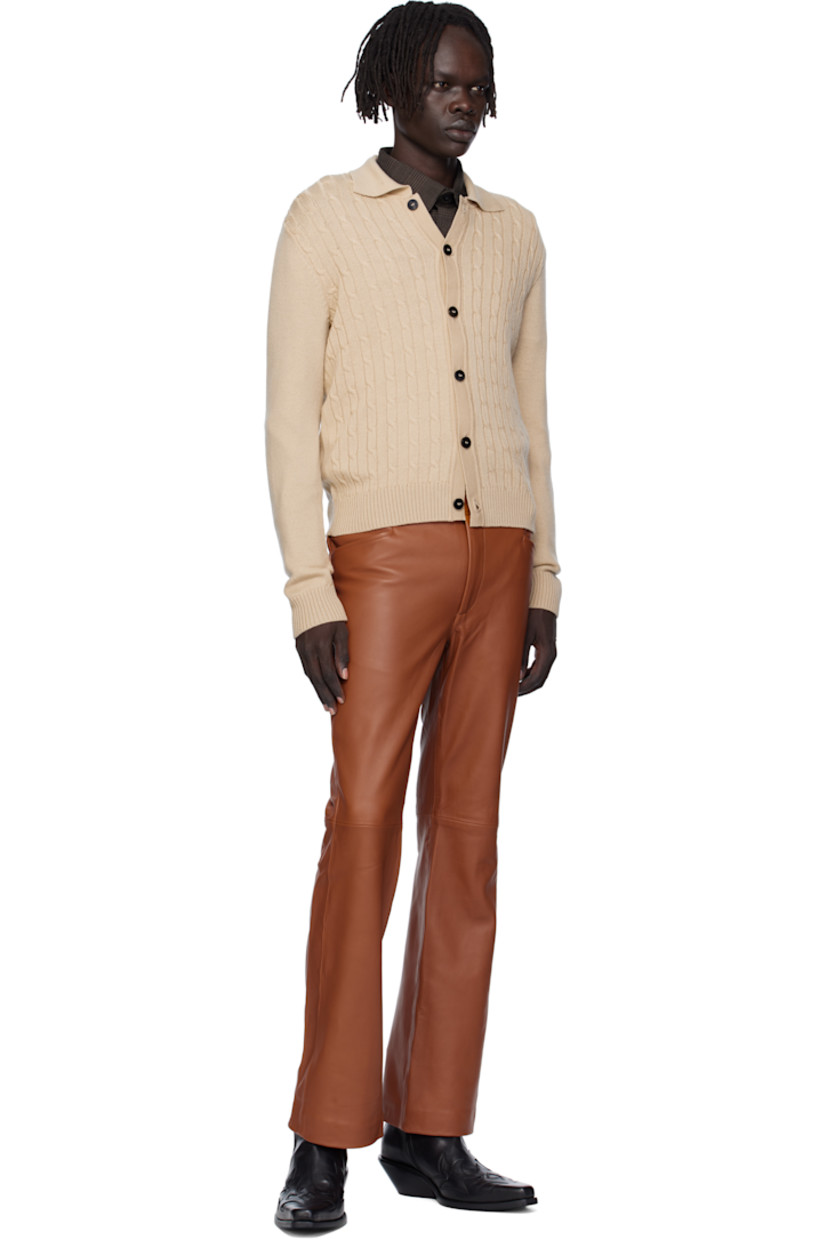 Cable-knit virgin wool cardigan.

· Rib-knit spread collar, placket, hem, and cuffs
· Button closure

Supplier color: Camel