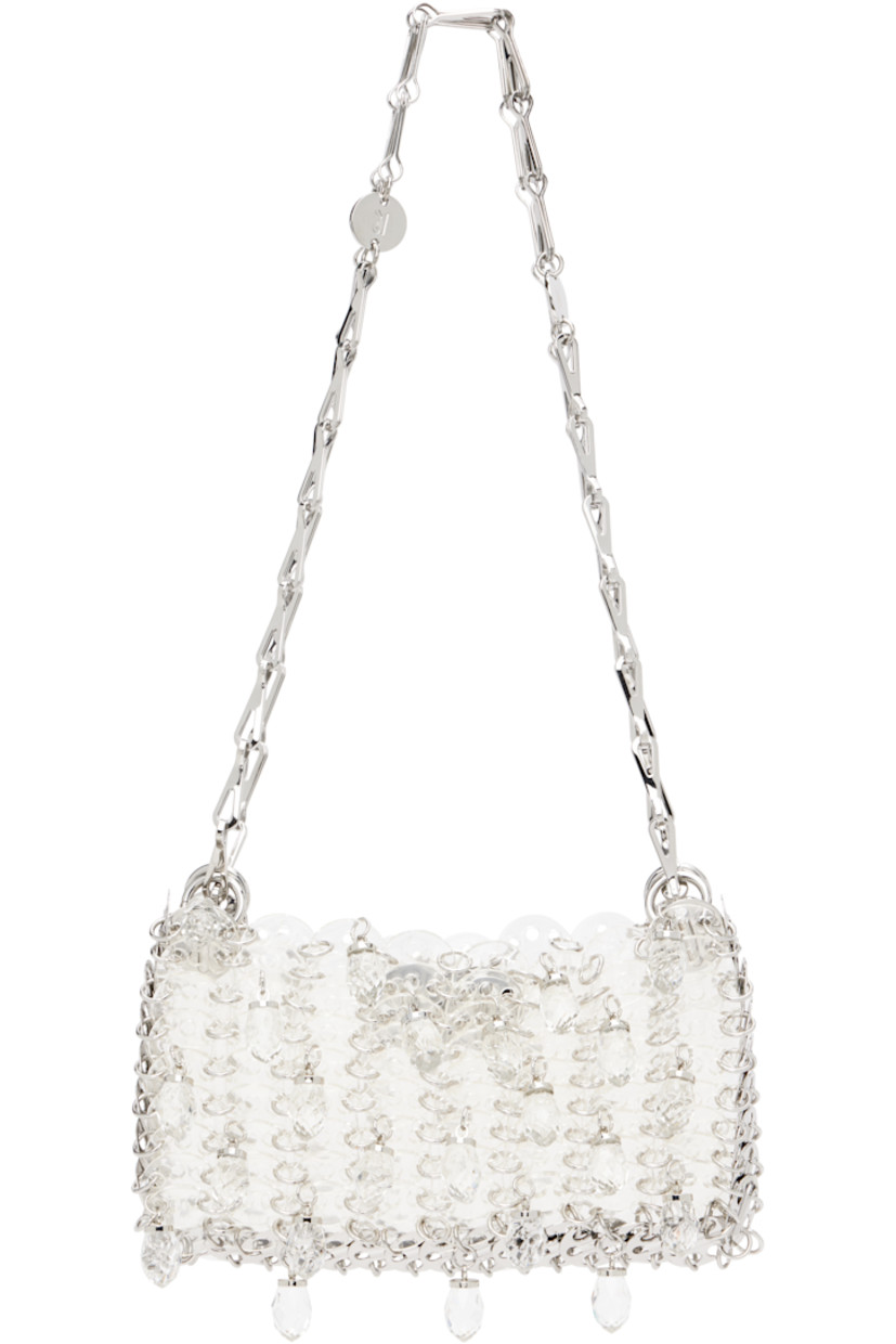 Handcrafted transparent resin chain mail-style shoulder bag.

· Sliding chain-link shoulder straps
· Logo plaques at shoulder strap
· Crystal-cut appliqués at face
· Magnetic closure
· Unlined
· Logo-engraved silver-tone hardware
· H4.5" x W6.5" x D1"

Supplier color: Transparent/Crystal