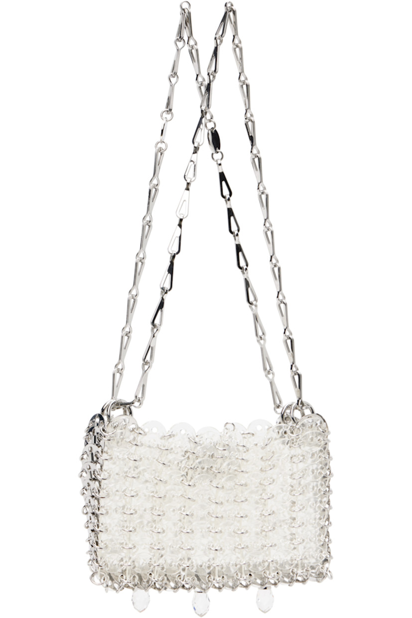 Handcrafted transparent resin chain mail-style shoulder bag.

· Sliding chain-link shoulder straps
· Logo plaques at shoulder strap
· Crystal-cut appliqués at face
· Magnetic closure
· Unlined
· Logo-engraved silver-tone hardware
· H4.5" x W6.5" x D1"

Supplier color: Transparent/Crystal