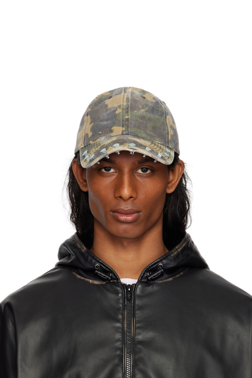 Cotton twill cap in khaki.

· Fading, distressing, and printed camouflage pattern throughout
· Embroidered eyelets at crown
· Text printed at face
· Hardware at curved brim
· Cinch fastening

Available exclusively at SSENSE.

Supplier color: Green