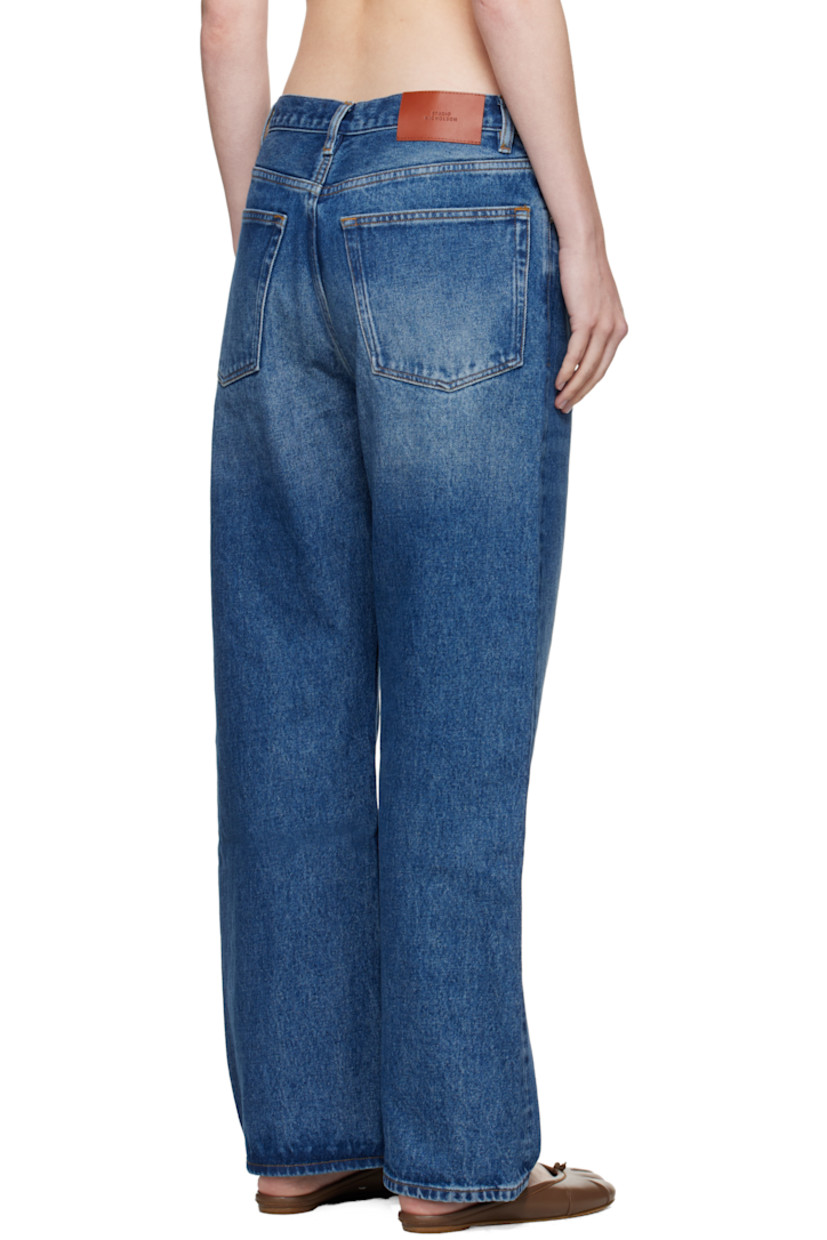 Non-stretch regenerative cotton-blend denim jeans.

· Fading and whiskering throughout
· Wide-leg
· Belt loops
· Five-pocket styling
· Zip fly
· Logo patch at back waistband
· Contrast stitching in yellow

Supplier color: Worn wash indigo
