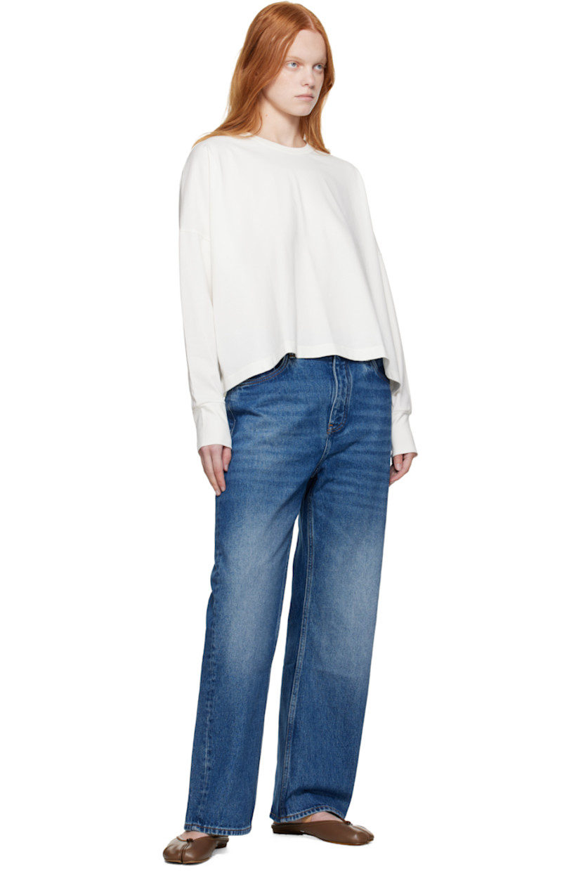 Non-stretch regenerative cotton-blend denim jeans.

· Fading and whiskering throughout
· Wide-leg
· Belt loops
· Five-pocket styling
· Zip fly
· Logo patch at back waistband
· Contrast stitching in yellow

Supplier color: Worn wash indigo