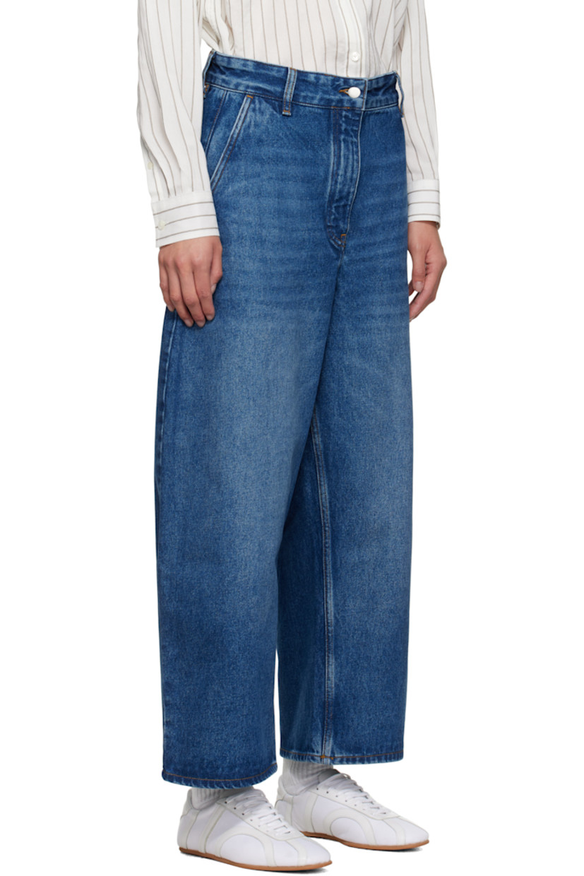 Non-stretch regenerative cotton-blend denim jeans. 

· Fading and whiskering throughout
· Wide-leg
· Belt loops
· Four-pocket styling
· Zip fly
· Cropped legs
· Curved outseams
· Dropped inseam
· Leather logo patch at back waistband
· Contrast stitching in tan

Supplier color: Worn wash indigo