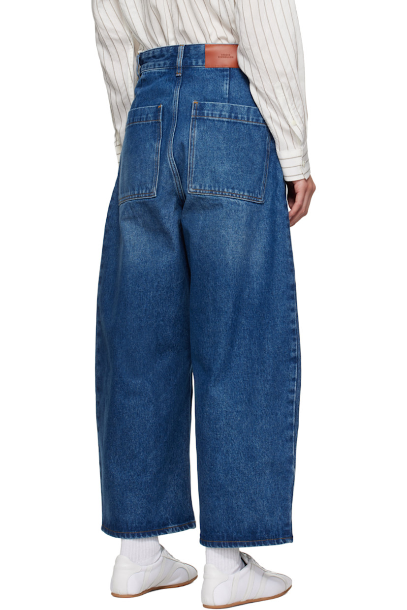 Non-stretch regenerative cotton-blend denim jeans. 

· Fading and whiskering throughout
· Wide-leg
· Belt loops
· Four-pocket styling
· Zip fly
· Cropped legs
· Curved outseams
· Dropped inseam
· Leather logo patch at back waistband
· Contrast stitching in tan

Supplier color: Worn wash indigo