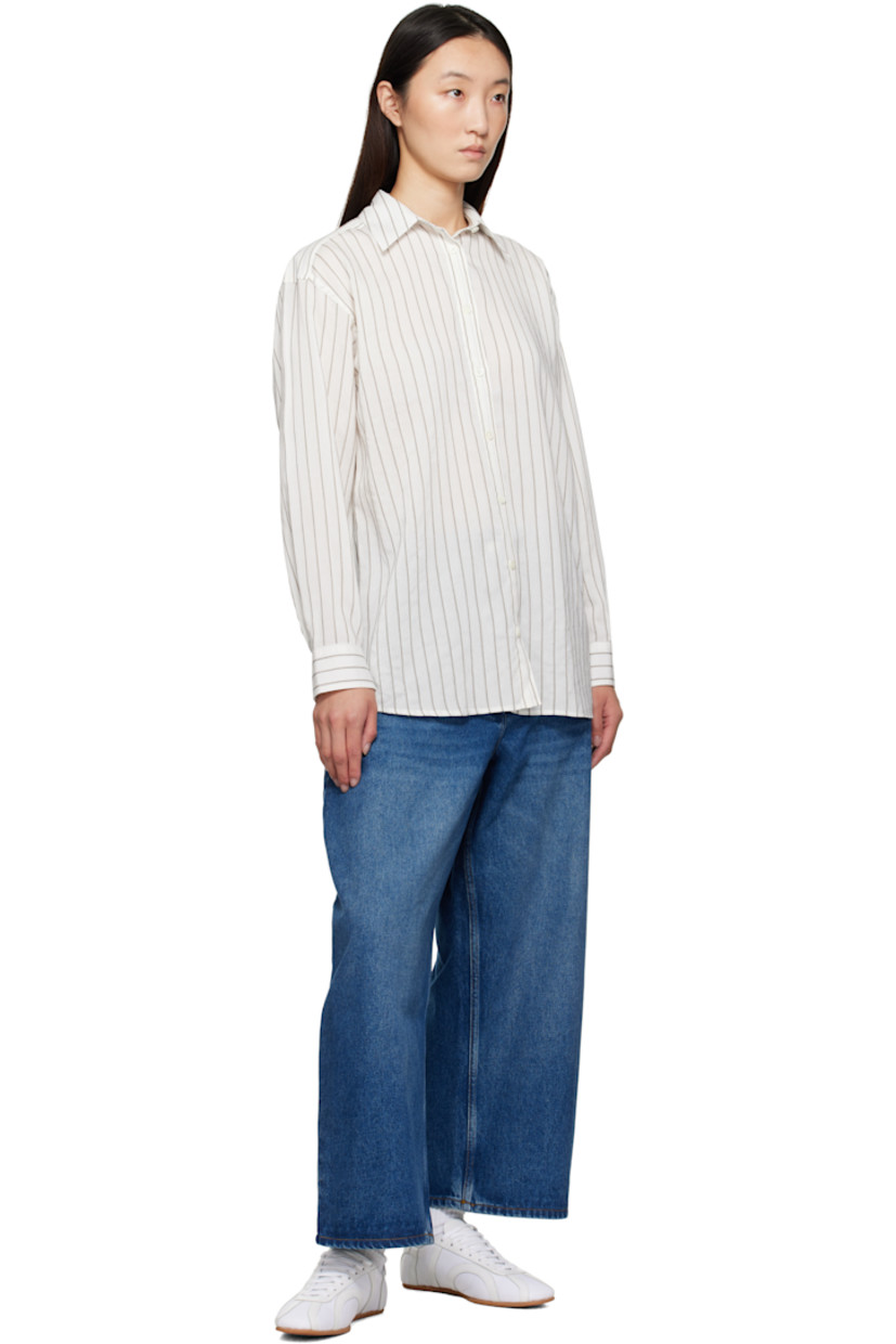 Non-stretch regenerative cotton-blend denim jeans. 

· Fading and whiskering throughout
· Wide-leg
· Belt loops
· Four-pocket styling
· Zip fly
· Cropped legs
· Curved outseams
· Dropped inseam
· Leather logo patch at back waistband
· Contrast stitching in tan

Supplier color: Worn wash indigo